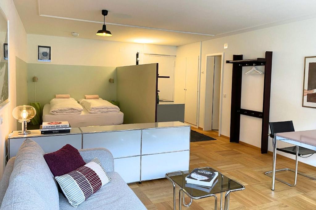 ein Wohnzimmer mit einem Sofa und einem Bett in der Unterkunft Apartment 302 - Zentrales Studio in Engelberg
