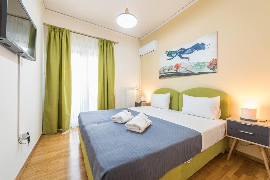 1 dormitorio con 1 cama con 2 toallas en Over The Town Urban 1BR Apt. 7' to Thiseio Metro en Atenas