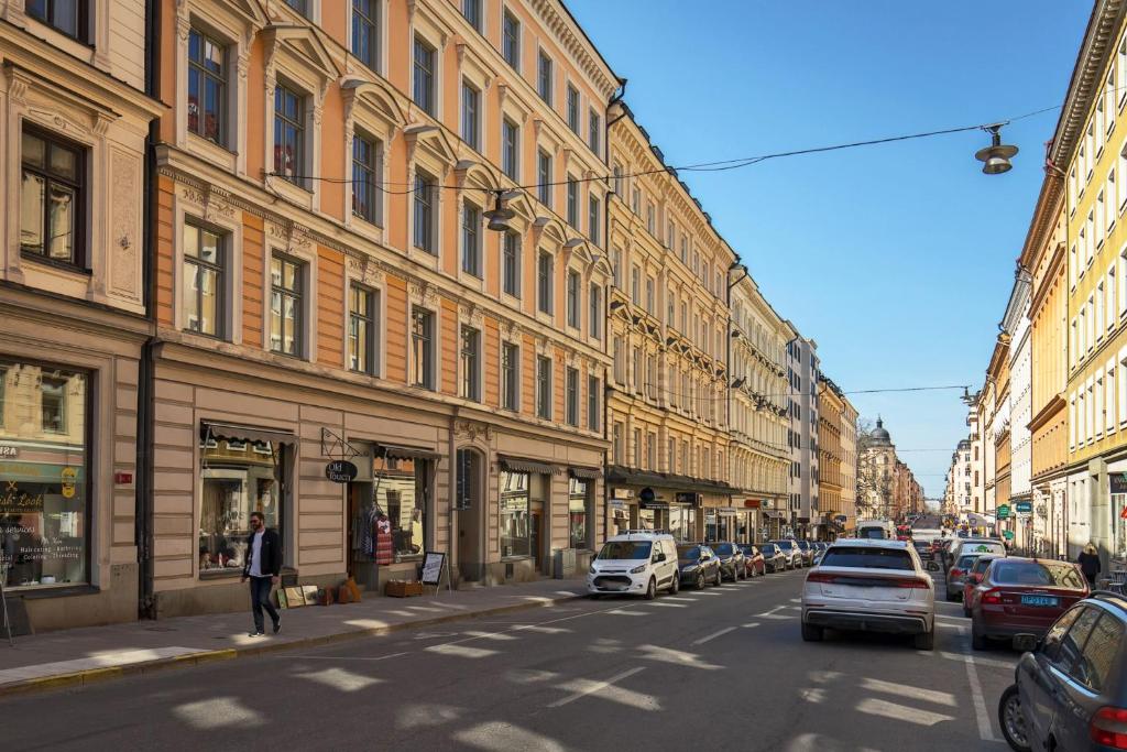 a city street with cars parked on the sides of buildings at Stockholm Central City Apartment! in Stockholm