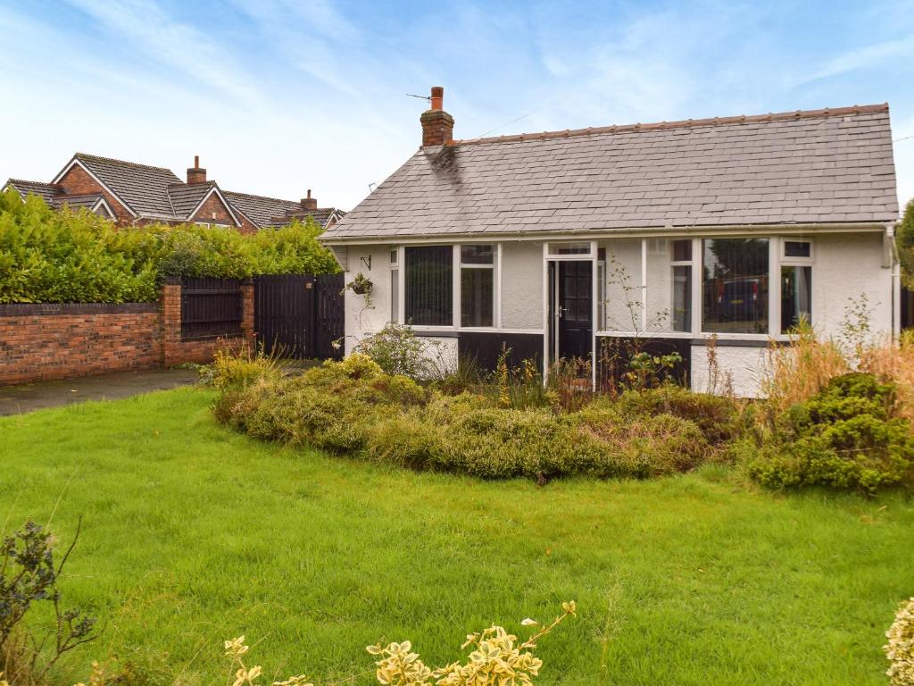 a white house with a yard in front of it at Gatesgarth in Longton