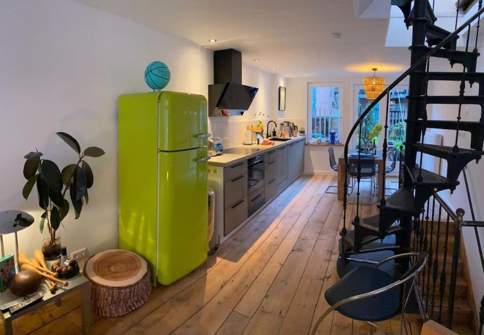 eine Küche mit einem grünen Kühlschrank und einer Treppe in der Unterkunft City-beach apartment nearby Amsterdam in Hoorn