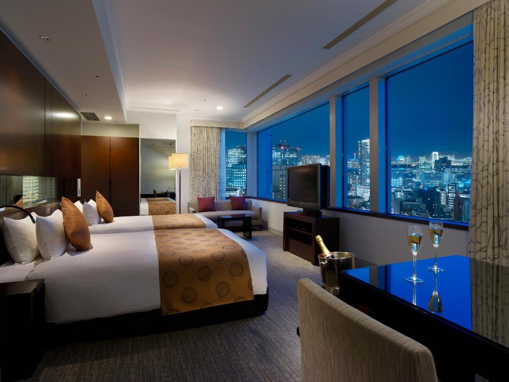 a hotel room with a bed and a view of a city at Hotel The Celestine Tokyo Shiba in Tokyo