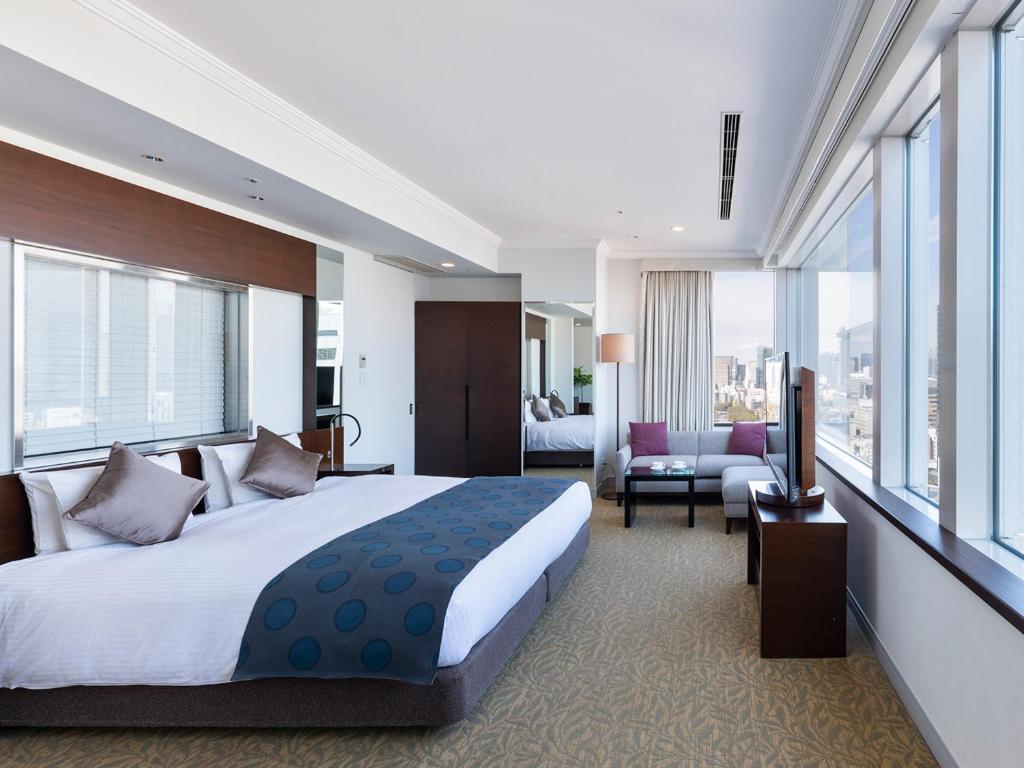 a bedroom with a large bed and a living room at Hotel The Celestine Tokyo Shiba in Tokyo