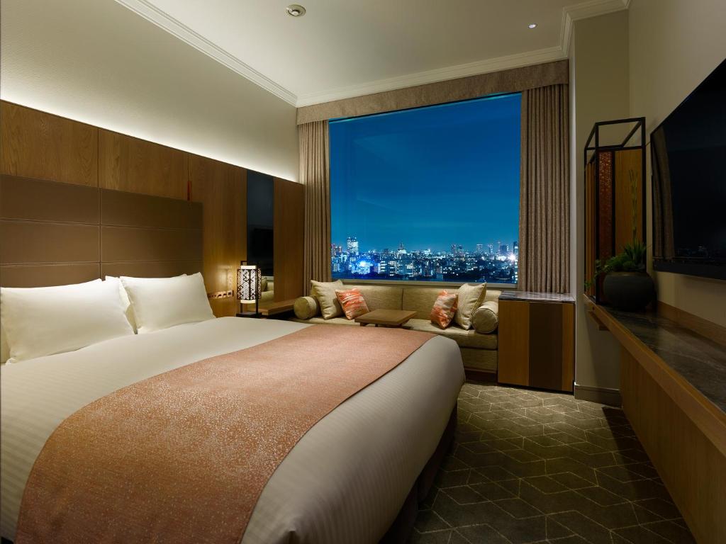 a hotel room with a large bed and a large window at Hotel The Celestine Tokyo Shiba in Tokyo