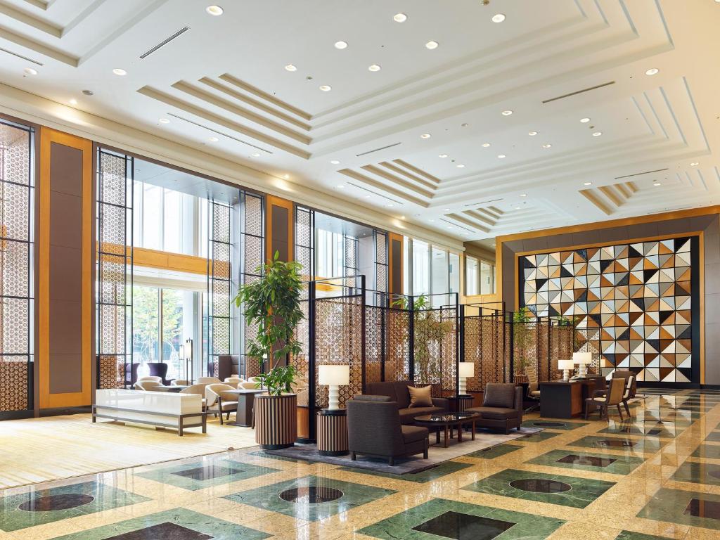 a lobby with chairs and tables and windows at Hotel The Celestine Tokyo Shiba in Tokyo