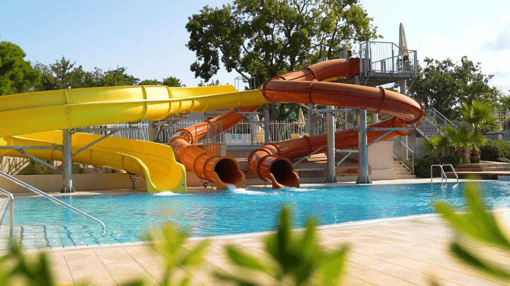 a water slide in a swimming pool at Easyatent Mobile home Bijela Uvala in Poreč