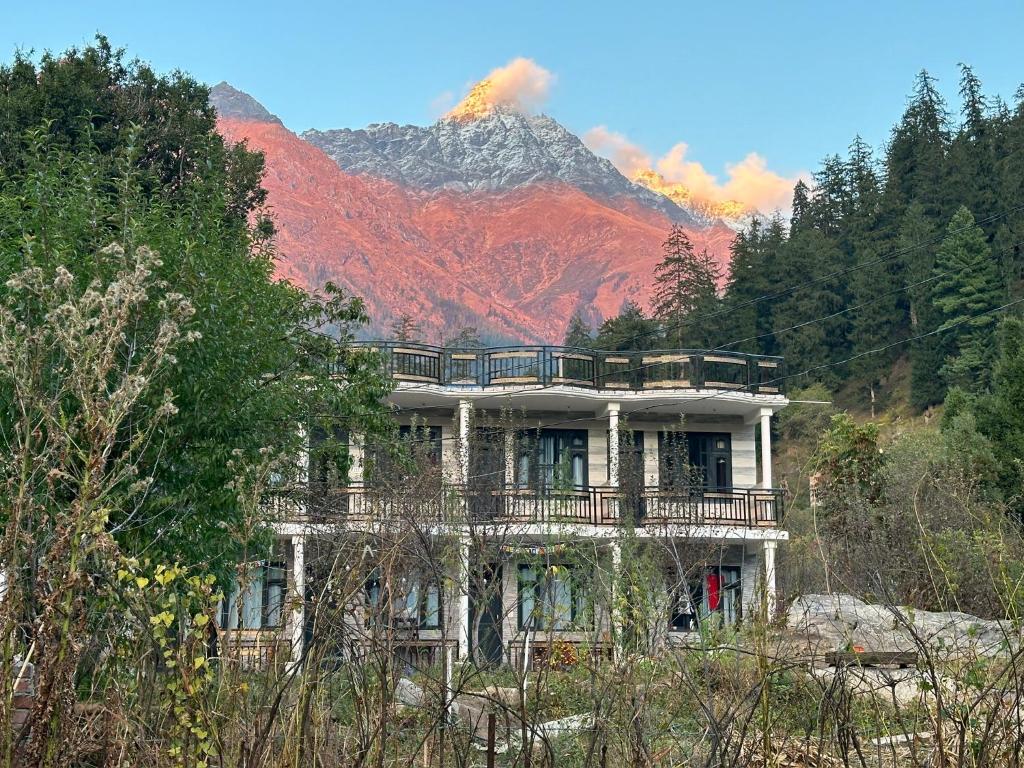 a house on a hill with a mountain in the background at Rare House in Kalgha