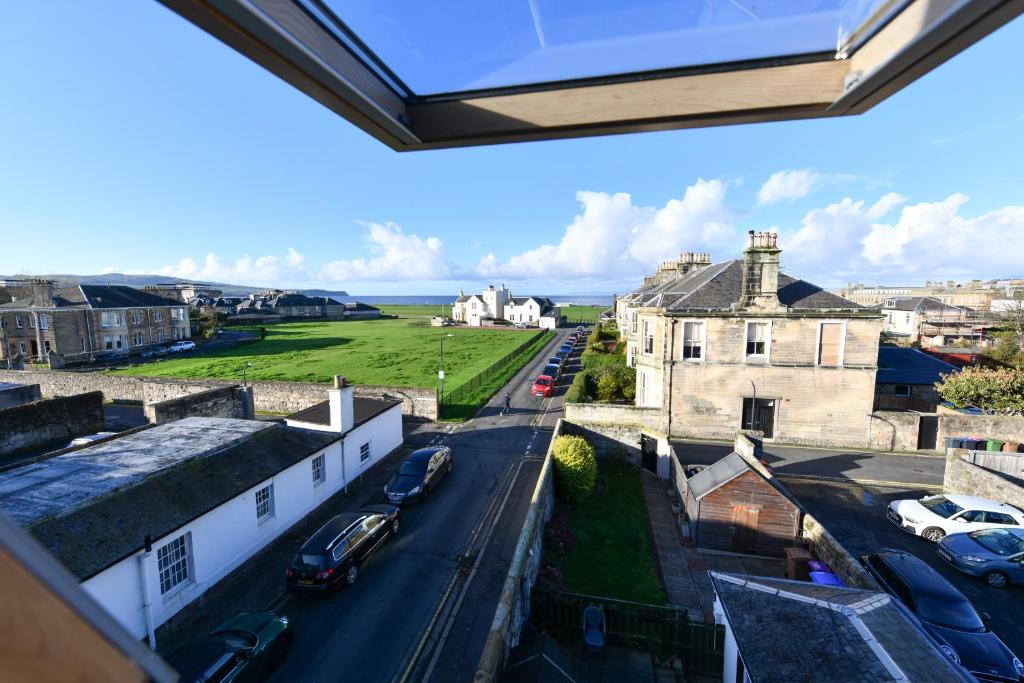 a view from the roof of a building with cars parked on the street at Pladda View in Ayr