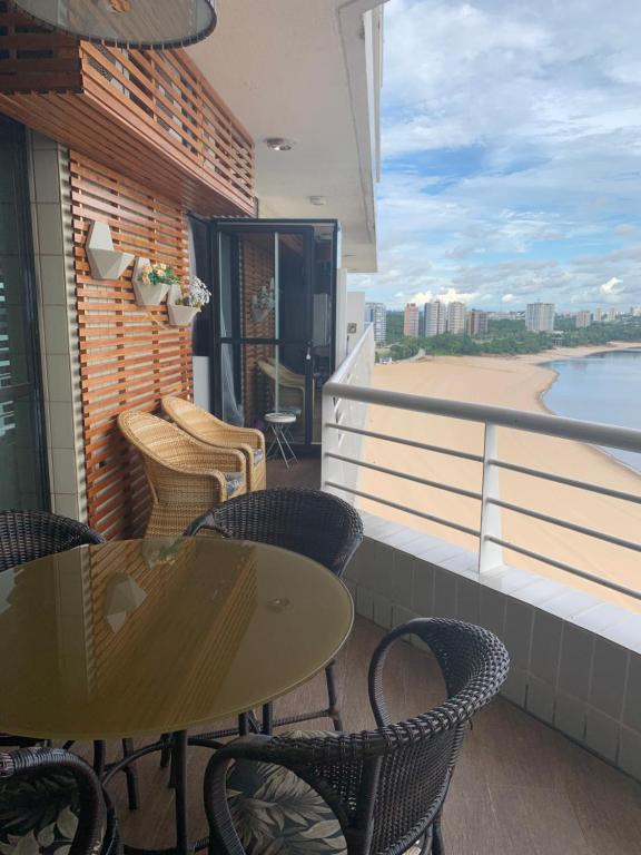a balcony with tables and chairs and a view of the beach at Tropical executive in Manaus