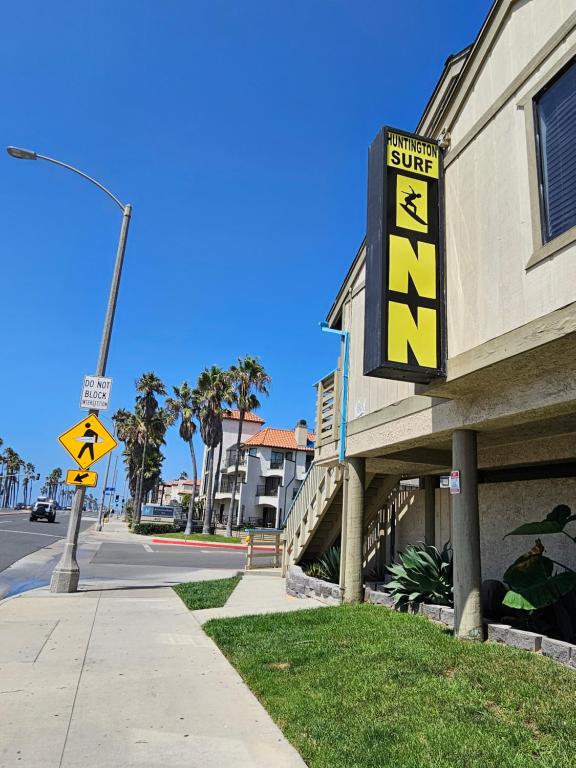 una señal para un hotel con una señal para un super hotel en Huntington Surf Inn en Huntington Beach