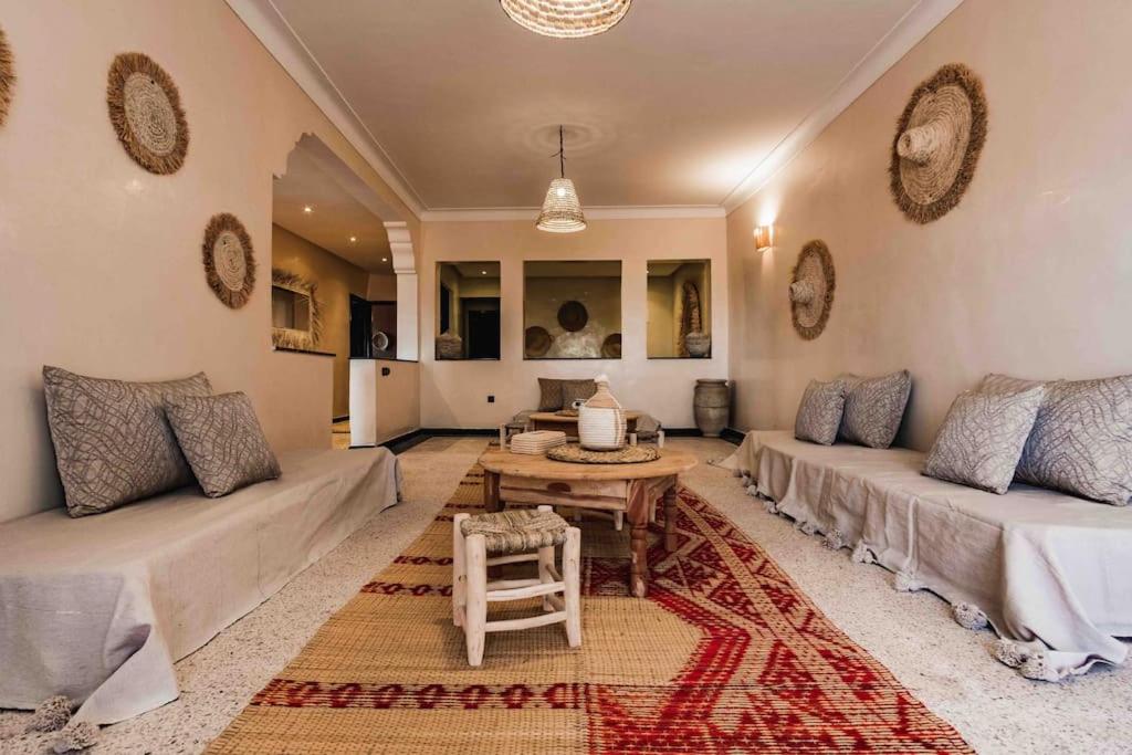 a living room with two couches and a table at Central Majorelle Apartment Sleeps 4 in Marrakesh