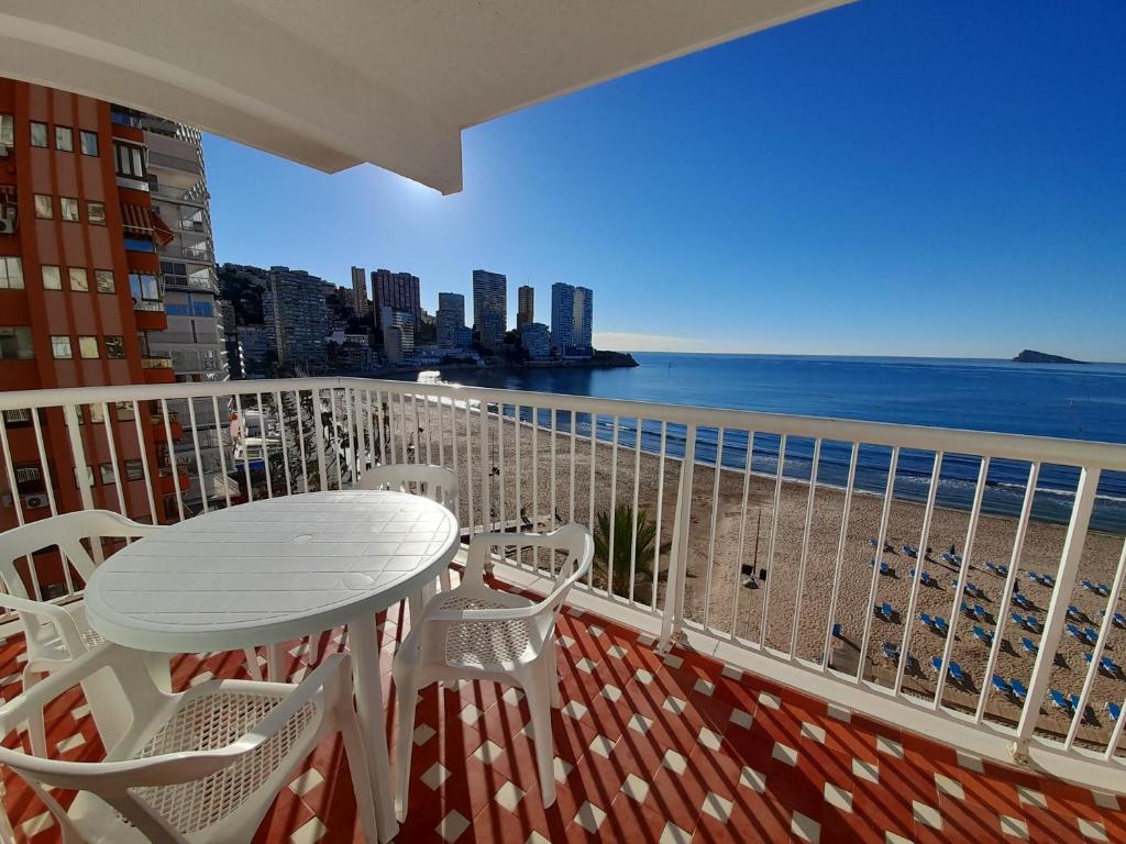 a balcony with a table and chairs and the ocean at Veracruz-Fincas Benidorm in Benidorm