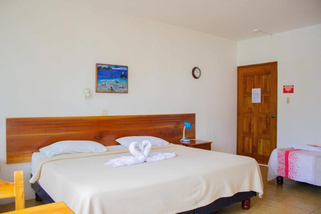 Postel nebo postele na pokoji v ubytování Galapagos Verde Azul