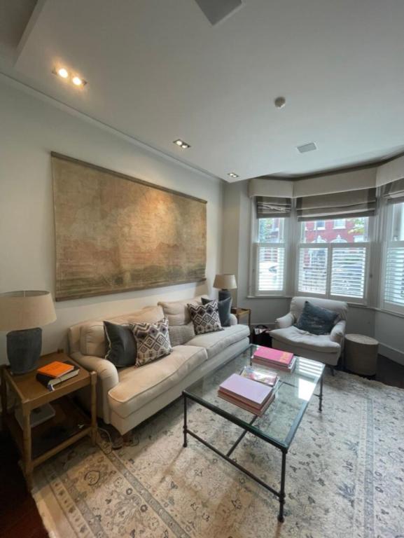 a living room with a couch and a table at Secluded & Serene 3BD Family Home - Wandsworth! in London