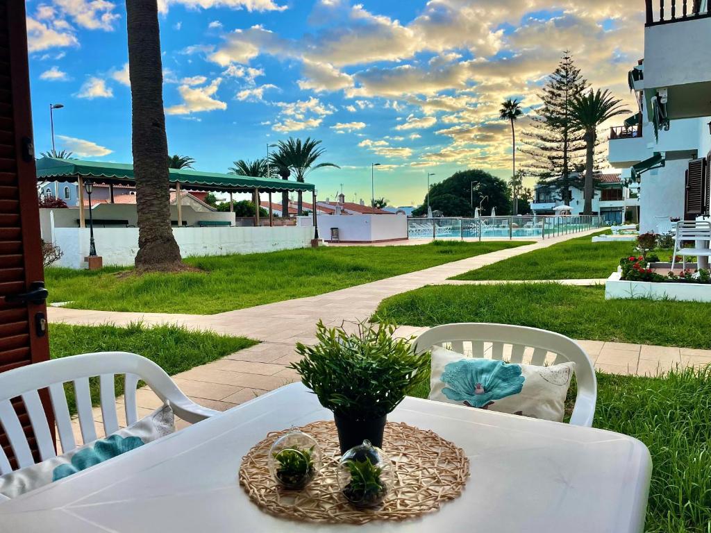 a white table with a plant on top of it at Los Balandros 117 by SunHousesCanarias in Maspalomas