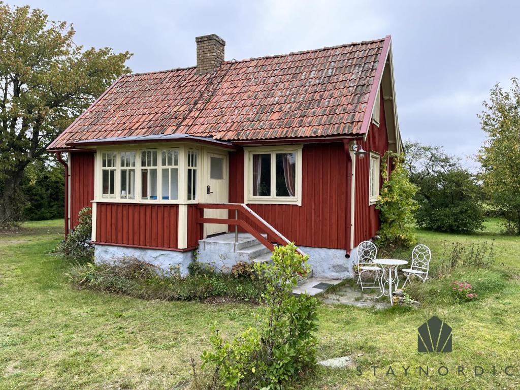 a red house with a red roof at Nice cottage located close to a bay in Skappevik in Bergkvara