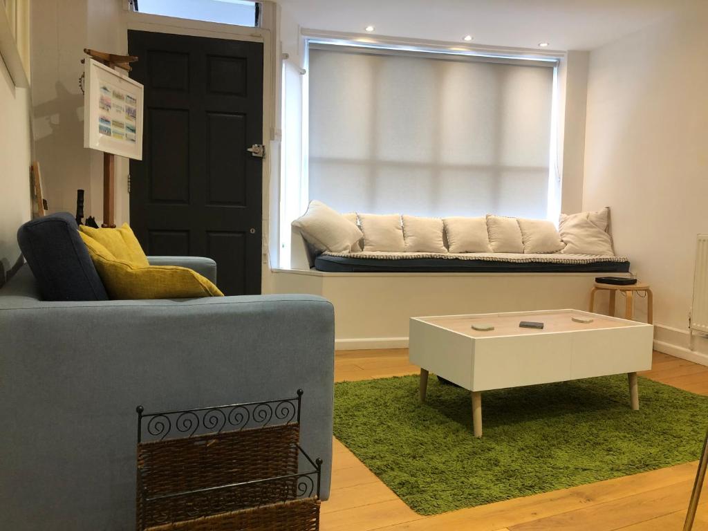 a living room with a couch and a coffee table at The Old Post Office,Hassocks in Ditchling