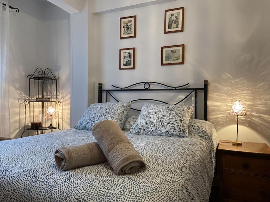 a bed with a rolled up towel on top of it at Los Angeles House in Sopelana