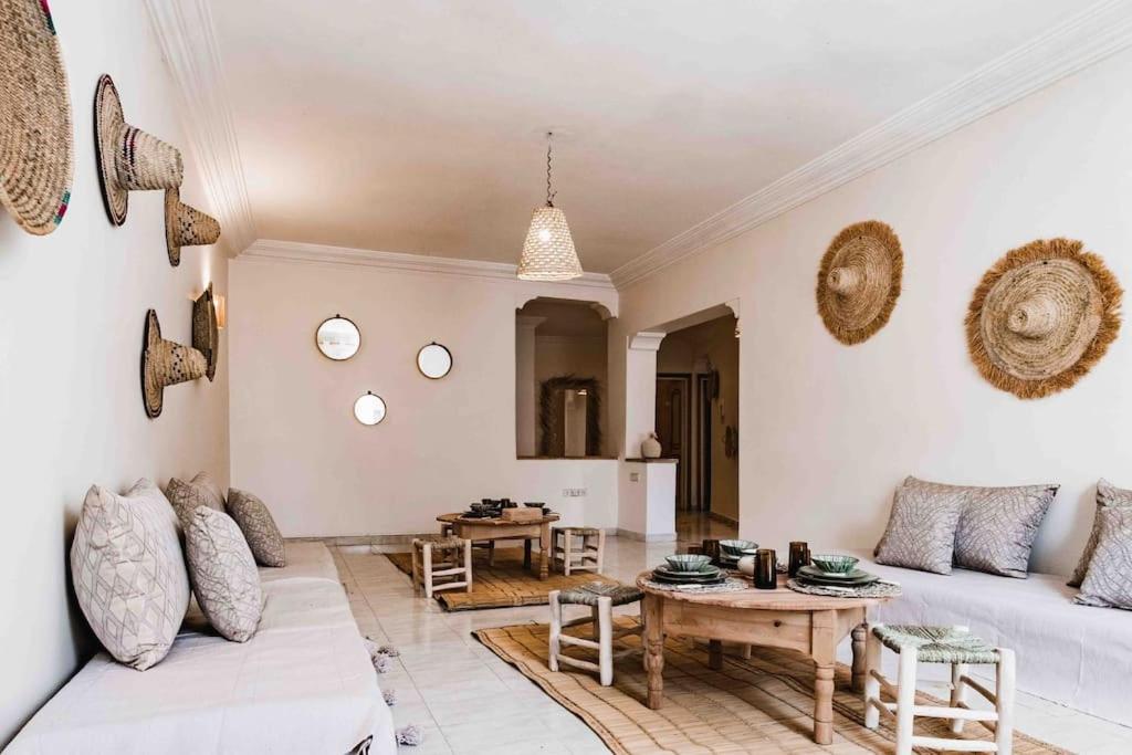 a living room with a white couch and a table at Central Majorelle Apartment in Marrakech