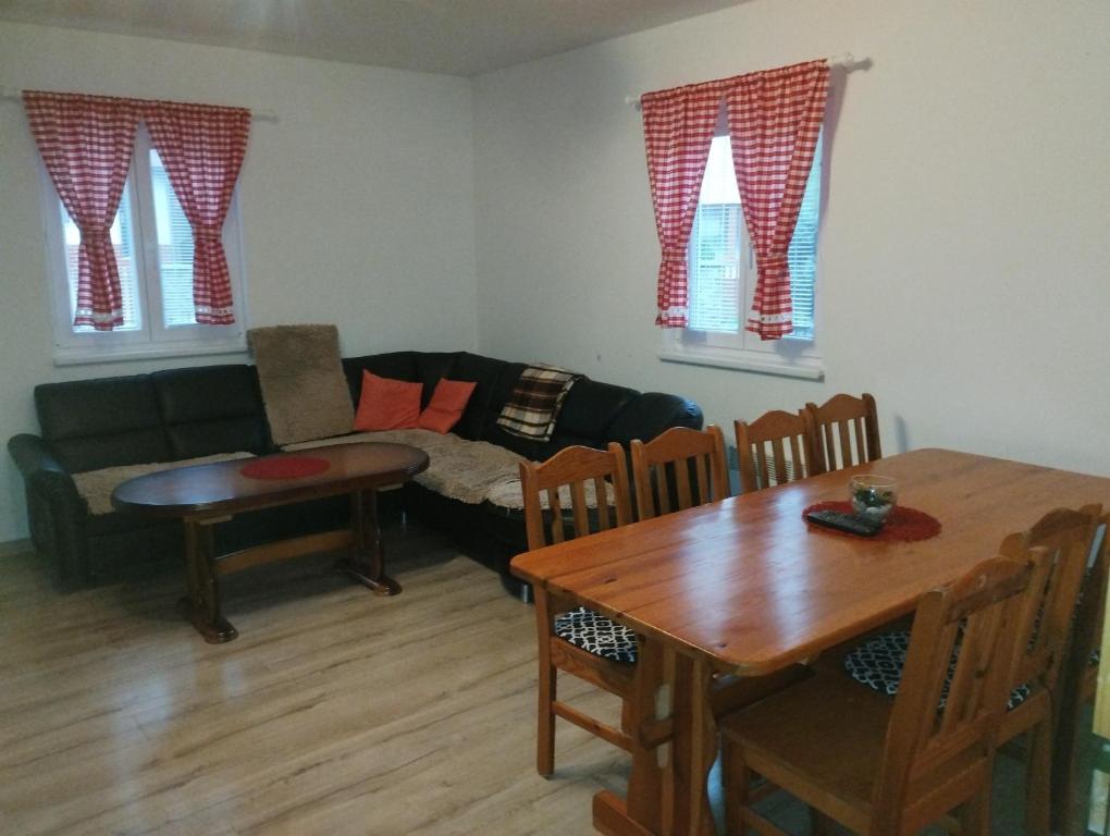 a living room with a couch and a table at Chalupa Mária in Terchová