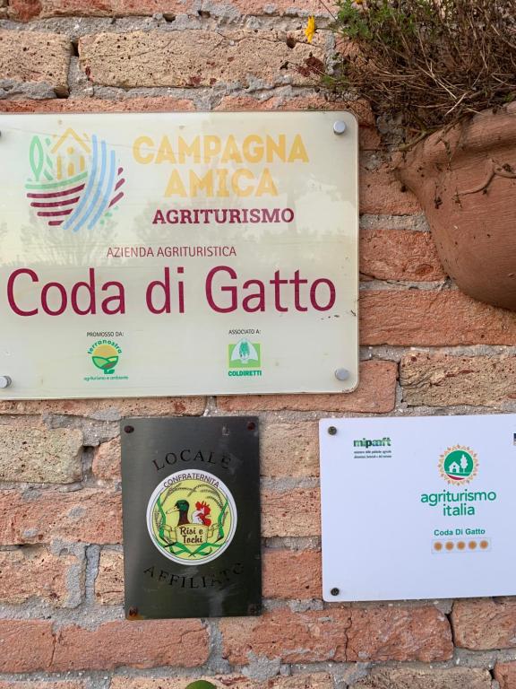 una señal para un restaurante en una pared de ladrillo en Agriturismo coda di gatto, en Eraclea