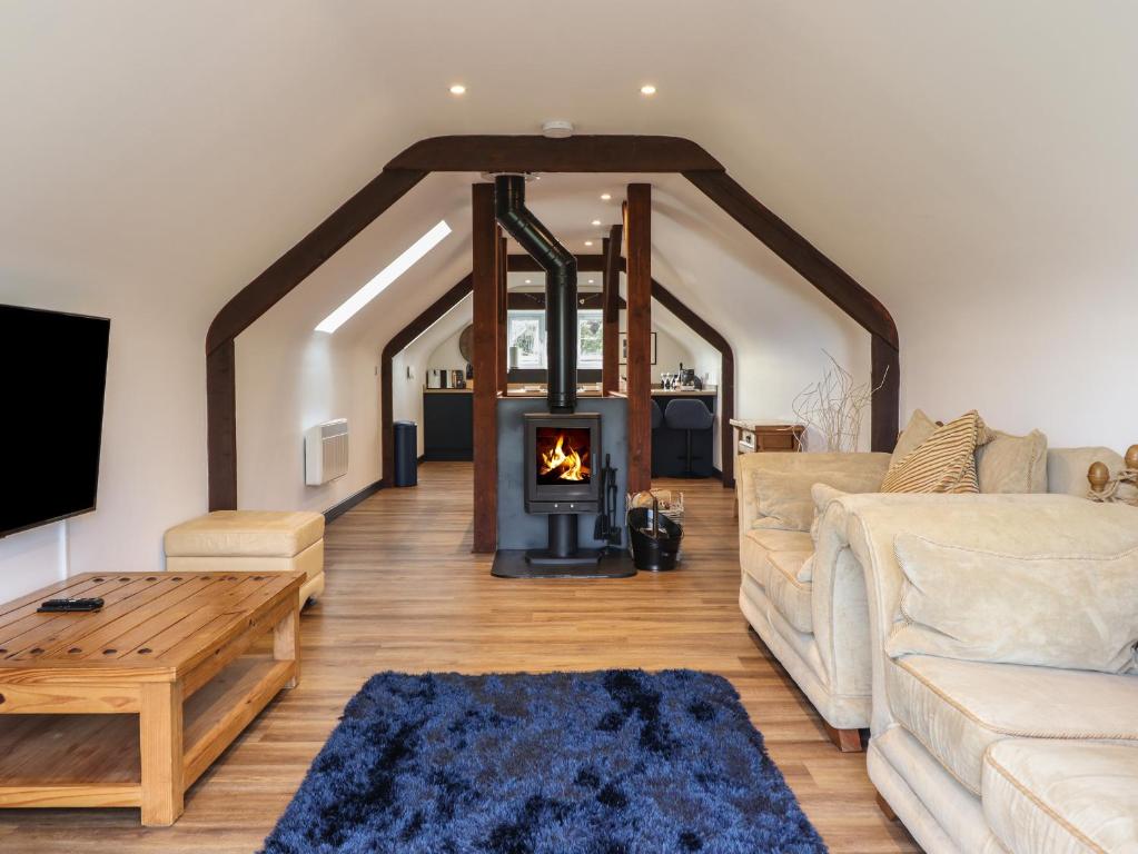 a living room with a couch and a fireplace at Bryn Eglwys Cottage in Tywyn