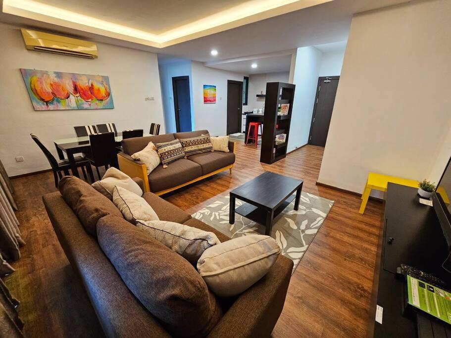 a living room with a couch and a table at Lovely Vivacity Jazz 2 Cozy Condo 2 Card LV11B in Kuching