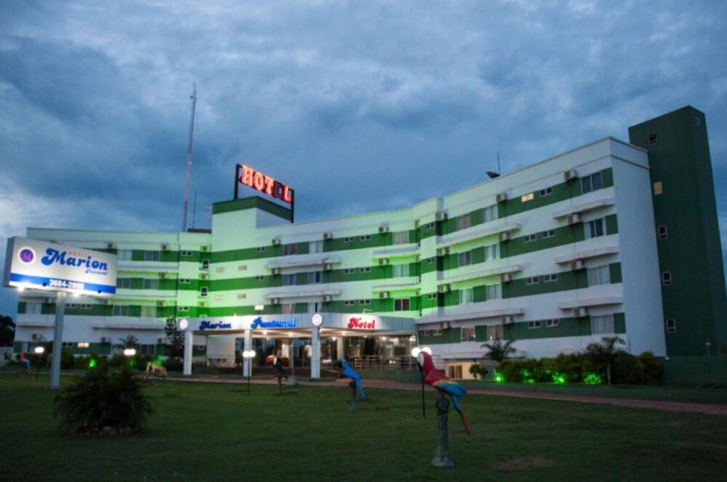 a large building with people standing outside of it at Marion Pantanal Hotel in Várzea Grande