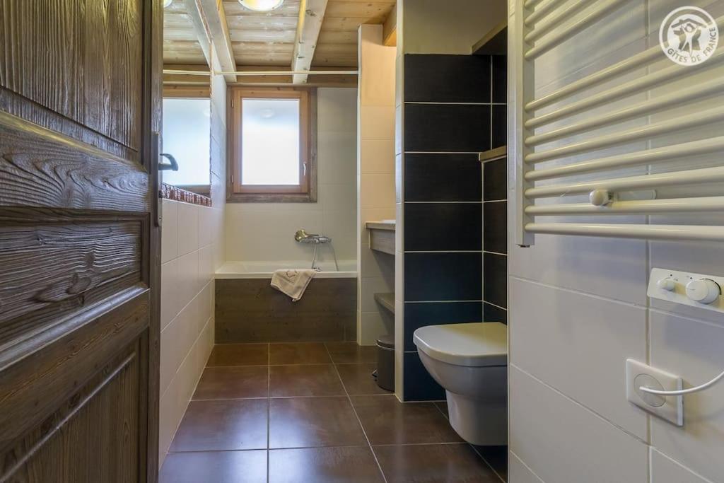 a bathroom with a toilet and a sink and a window at Chalet Bio Corti 6p. 3 ch proche pistes&#47;commerces in Champagny-en-Vanoise