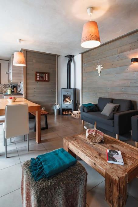 a living room with a couch and a table at Chalet Bio Corti 6p. 3 ch proche pistes&#47;commerces in Champagny-en-Vanoise