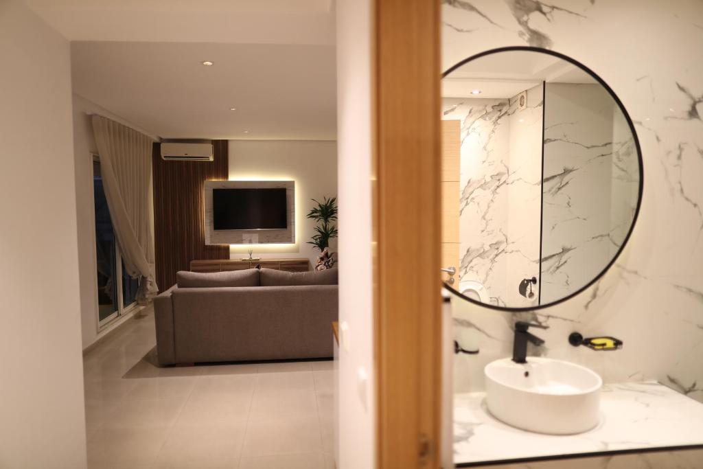 a bathroom with a sink and a mirror at Cozy Apartment with Veranda Downtown in Casablanca