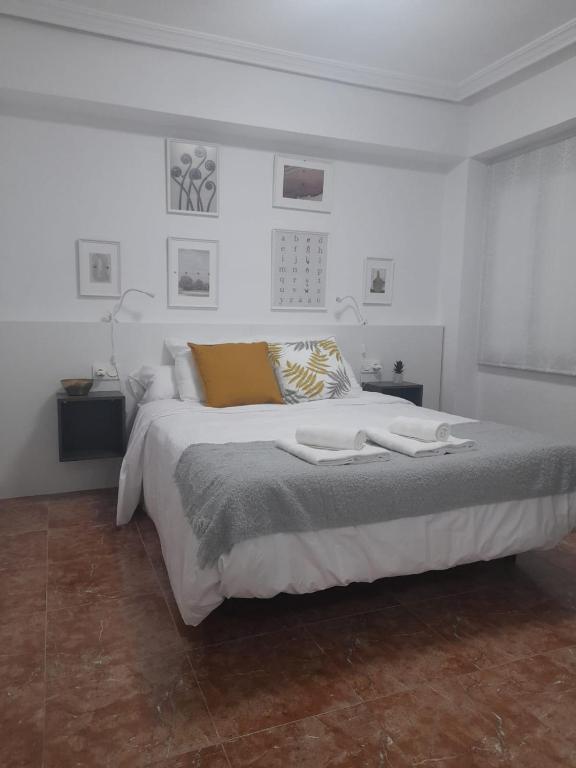 a white bedroom with a large bed in it at Mi casa de Molina in Molina de Segura