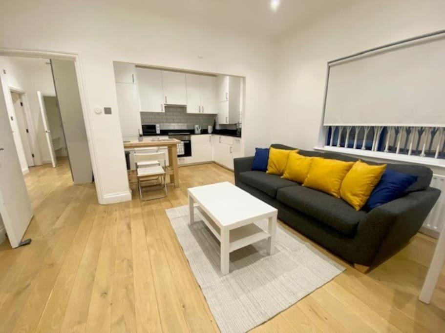 a living room with a couch and a table at 2 Bedroom Flat in Whitechapel! in London