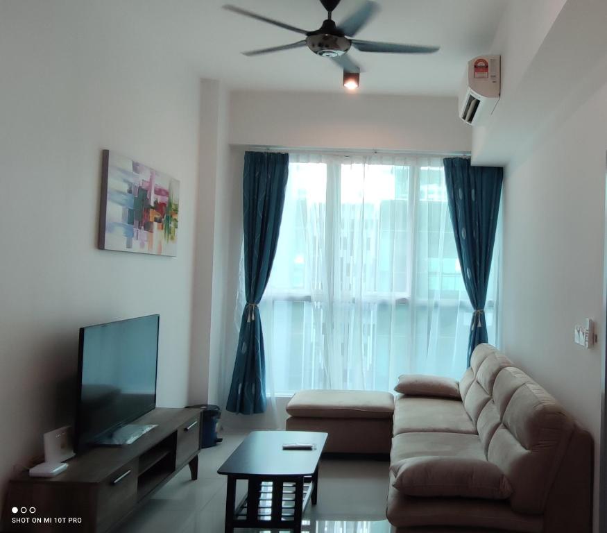 a living room with a couch and a tv at Leisure homestay@Sutera Avenue 2-0519 in Kota Kinabalu