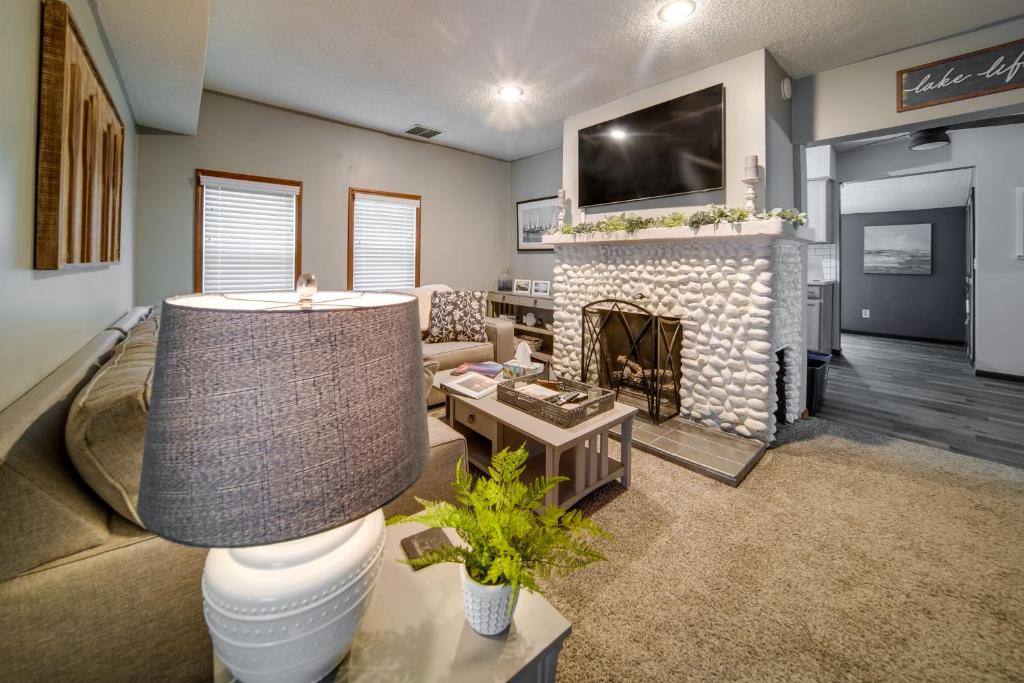 a living room with a couch and a fireplace at Cozy Erie Vacation Rental with Patio and Seasonal Pool in Erie