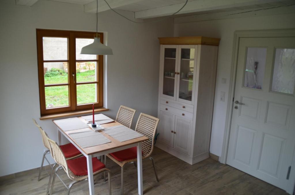 a dining room with a wooden table and chairs at Ferienwohnung Uckermarkblick in Ziehten