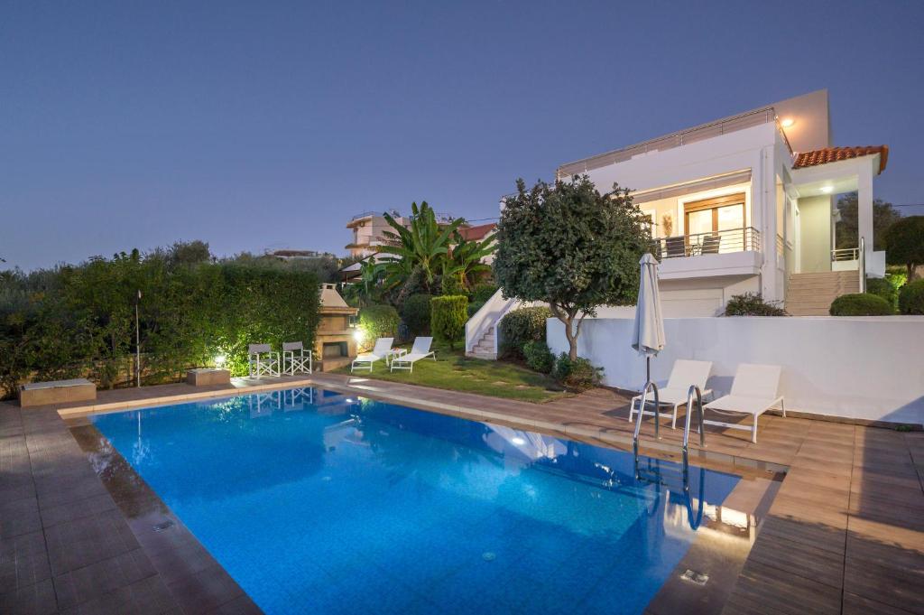 a swimming pool in front of a house at Villa Katerina in Chania Town