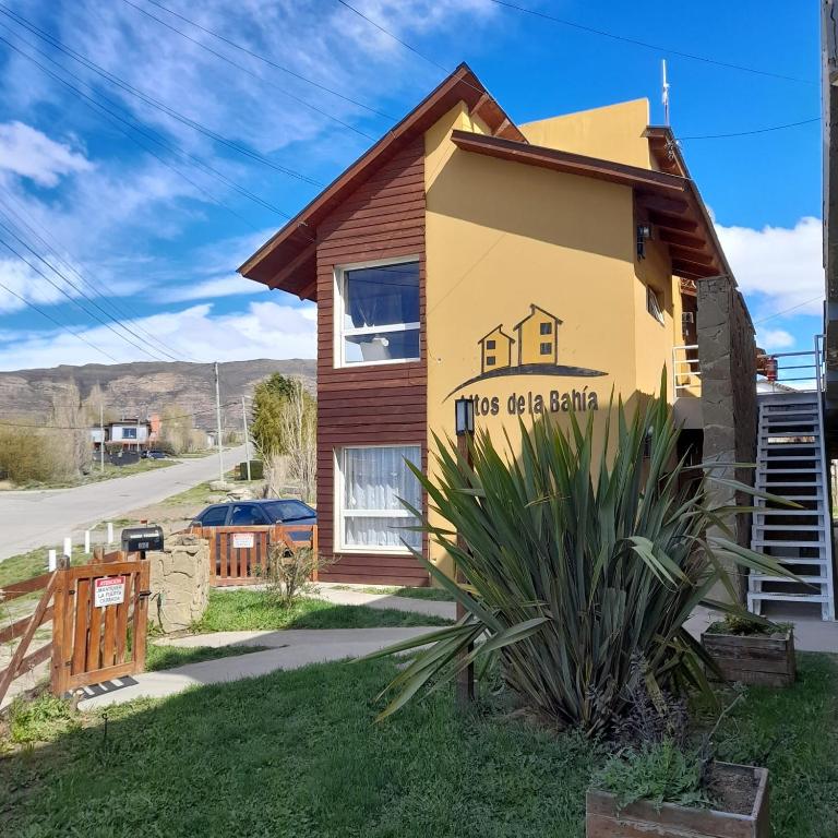 a house with a sign on the side of it at C & N - Altos de la Bahía in El Calafate