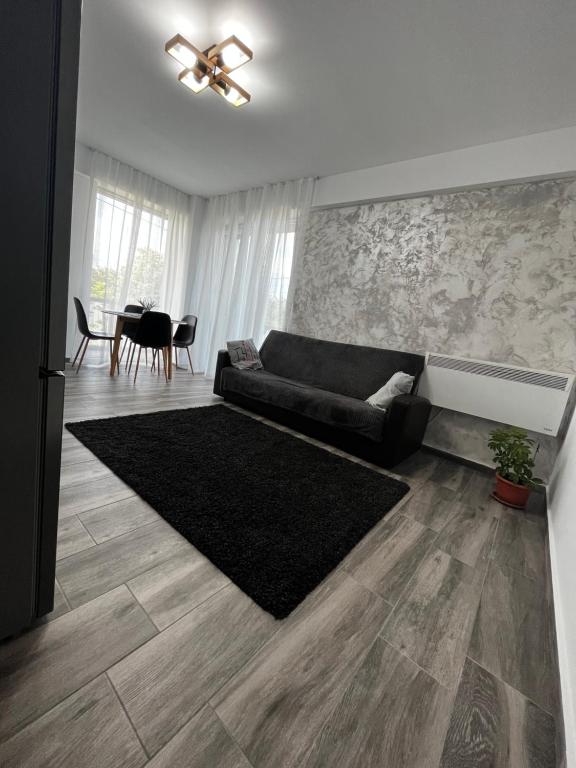 a living room with a couch and a table at Patrick apartament in Techirghiol