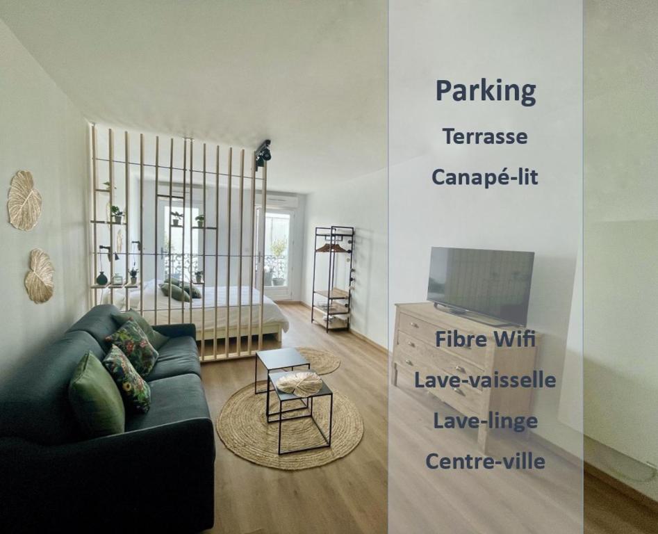 uma sala de estar com um sofá e uma televisão em ALP Chartres - Grand studio avec terrasse et parking em Chartres