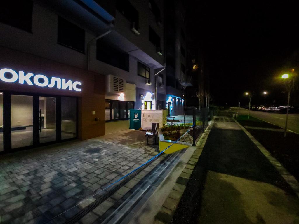 an empty street in front of a building at night at OOTA Soko Ha in Kragujevac