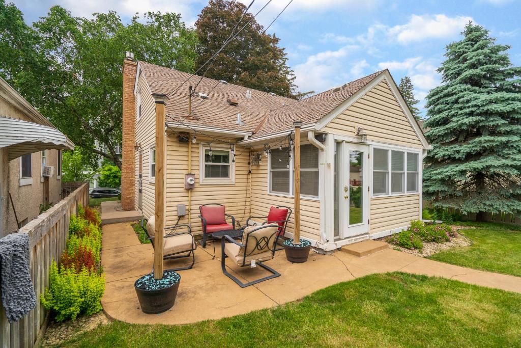 a small house with two chairs and a patio at Beard Avenue Bungalow! in Minneapolis