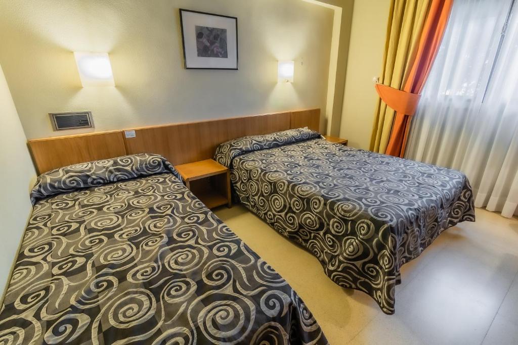 Postel nebo postele na pokoji v ubytování Hotel Alhama