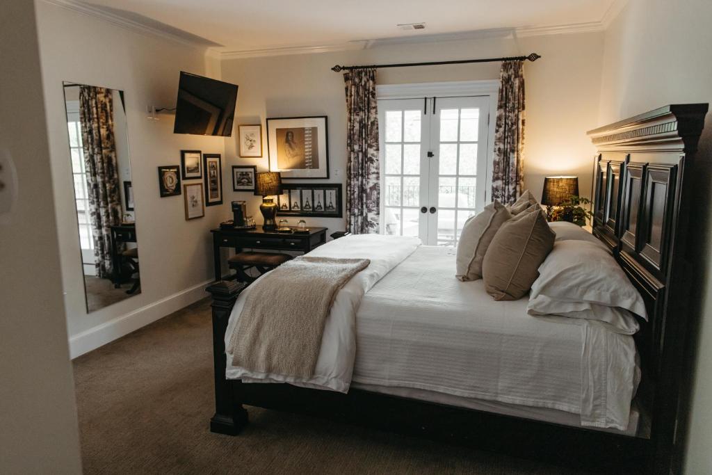 a bedroom with a large bed and a window at Southmoreland at Oak Street Mansion in Kansas City