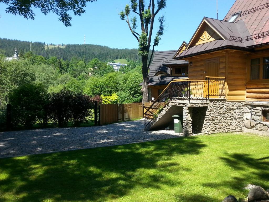 a house with a staircase leading up to a yard at Apartament Kościeliska 10A in Zakopane