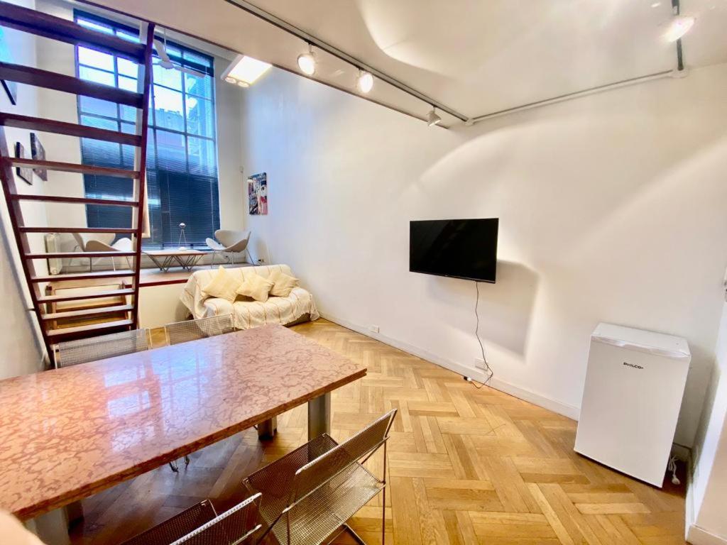 a living room with a table and a tv at Tucuman 685 in Buenos Aires