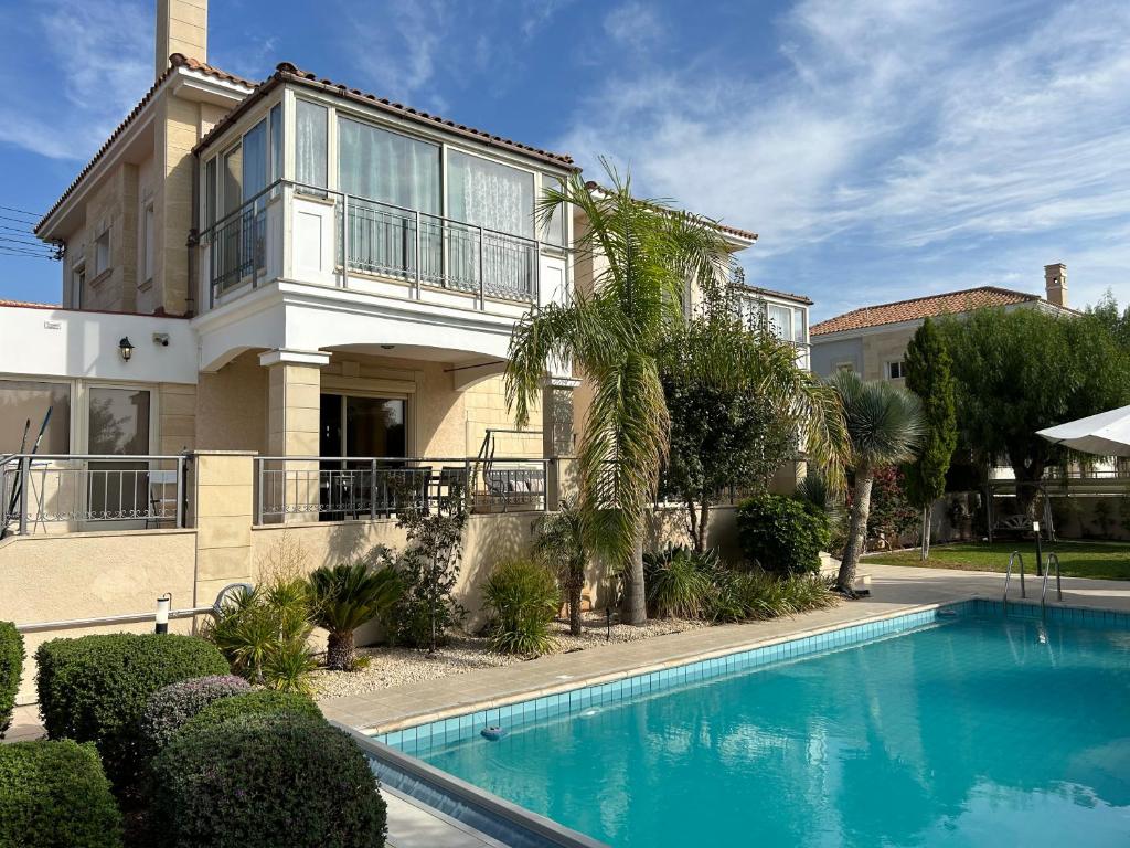 a house with a swimming pool in front of it at SeaView 5 Bedroom Villa with Private Pool in Limassol