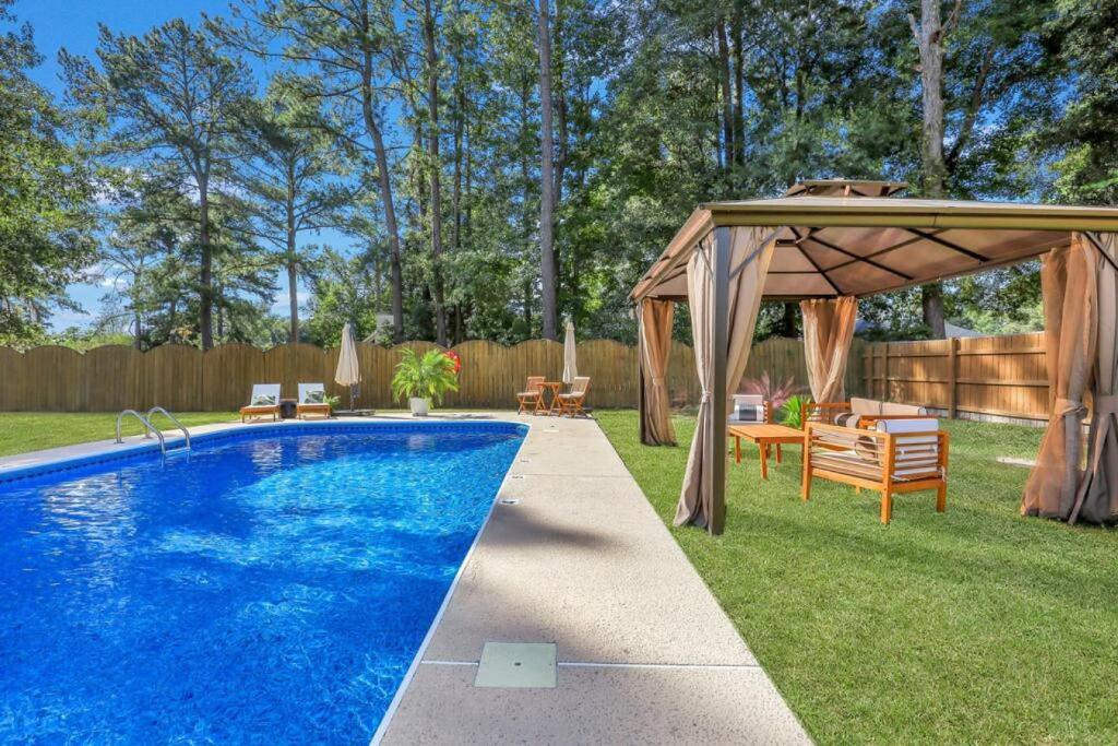 a swimming pool in a backyard with a gazebo at Savannah 5BR Pool, Jacuzzi, Firepit, Sports, Games in Savannah