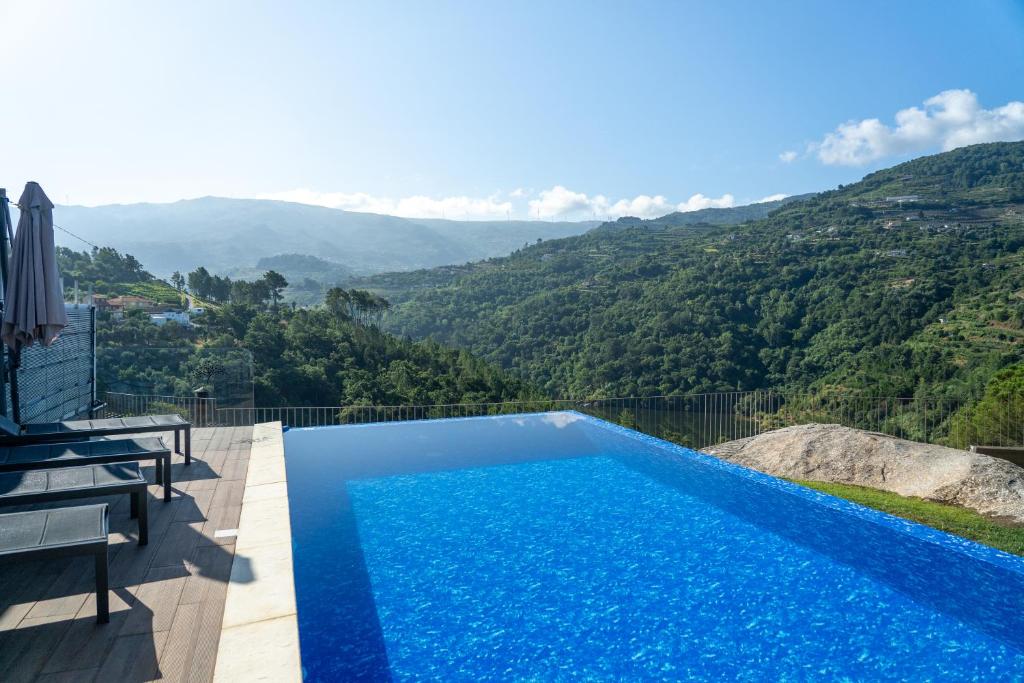 a swimming pool with a view of a mountain at Casa Douro River 