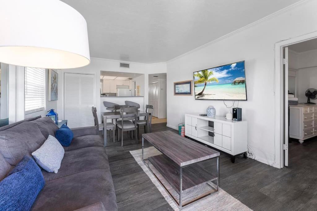 a living room with a couch and a table at Sandpiper Oceanfront 5F in Jacksonville Beach